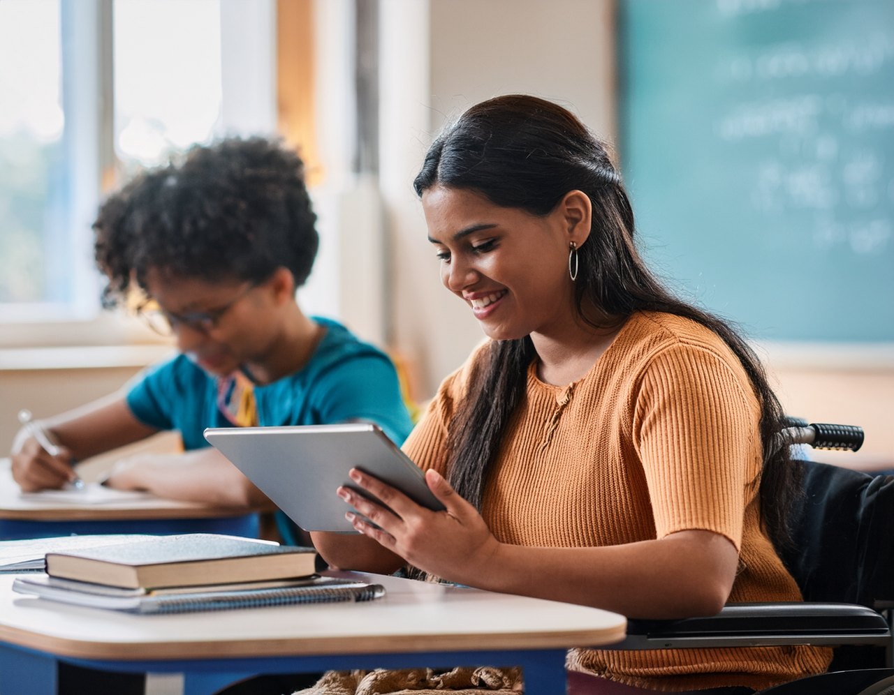 Assistive technology for disabilities: a student using a communication tablet in class