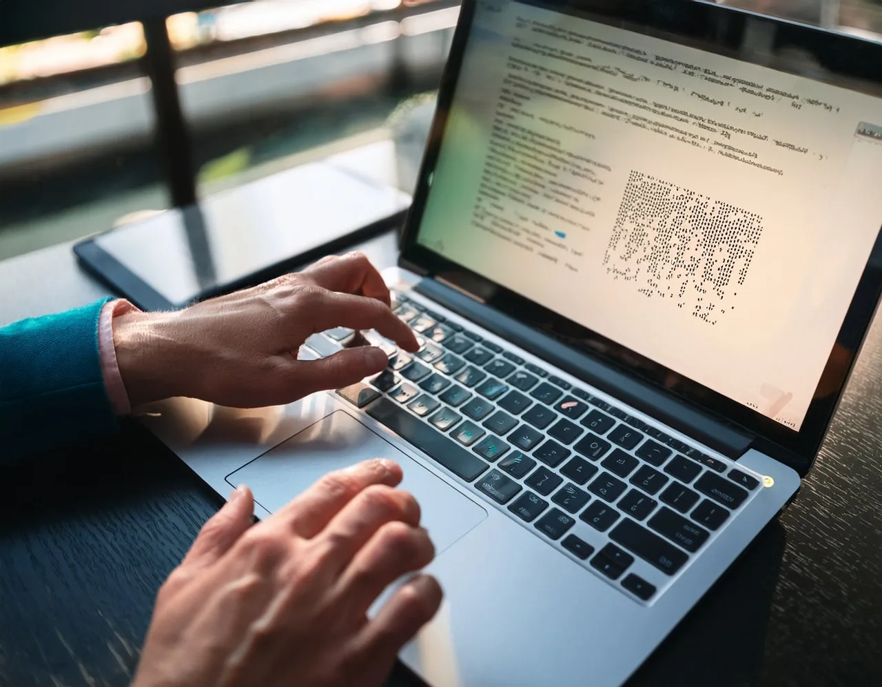 Braille display user reading a website on a laptop