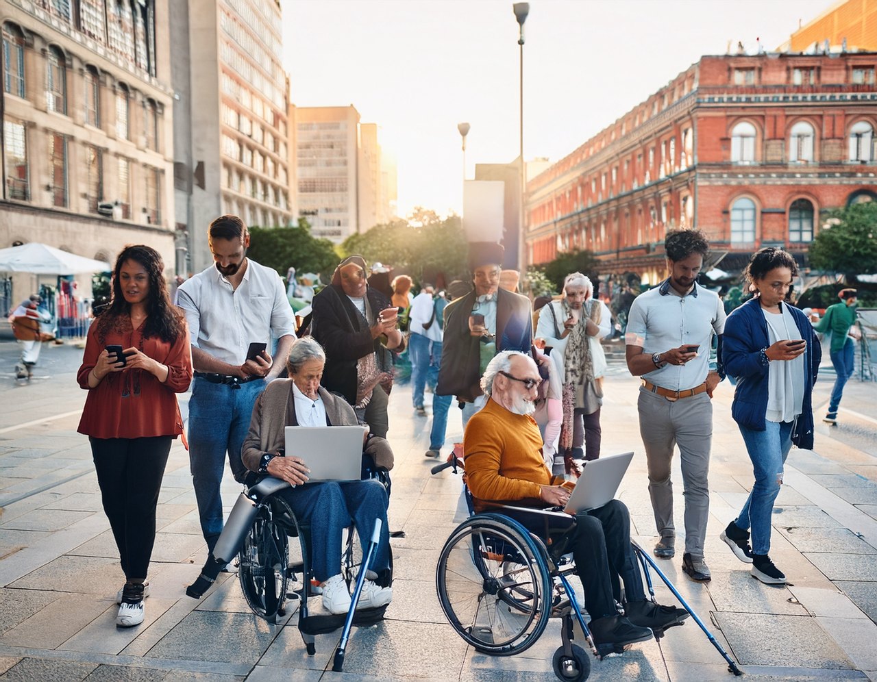 Diverse people of all abilities using phones and laptops