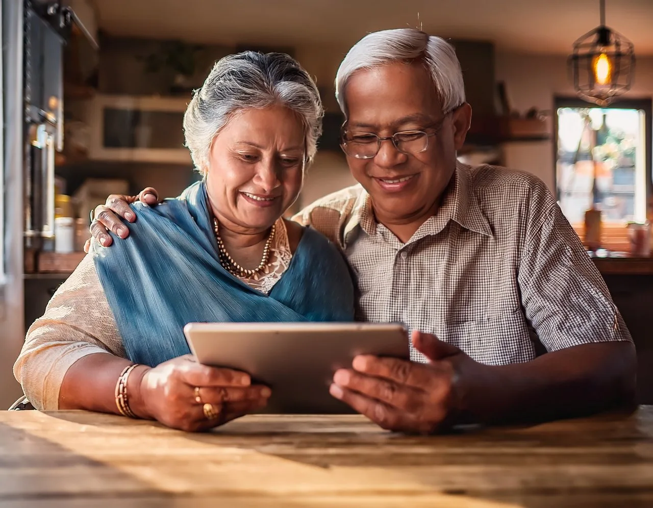Elderly couple shopping online on a tablet with large text